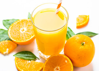 Orange juice in glass on white.