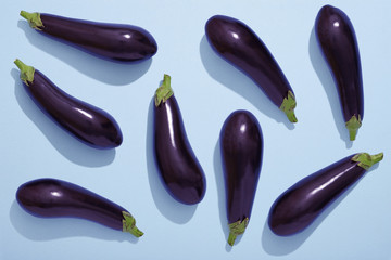 Aubergines on blue background, Eggplant flat lay