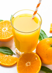 Orange juice in glass on white.