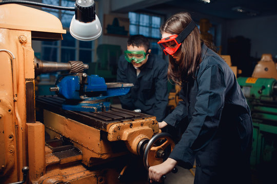 Mechanic engineer turner processes manufacturing steel parts in workshop of production. Concept industrial worker in factory.