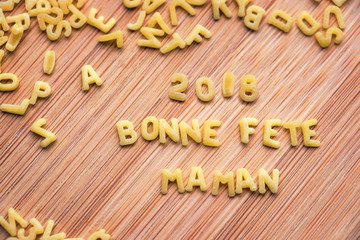 Pasta forming the text 2018 Bonne Fete Maman, meaning Happy Mothers Day in French