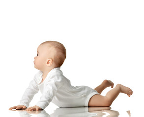7 month infant child baby  girl toddler lying in white shirt looking at the corner 