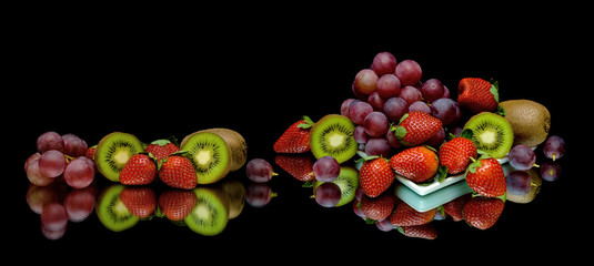 berries and fruits on a black background