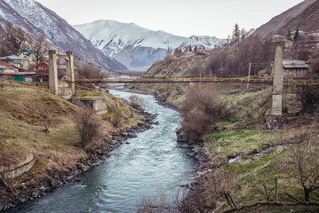 Fototapeta na wymiar Bridge over Terek River in Stepantsminda town in Greater Caucasus Range, Georgia