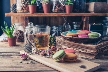 Serving table: tea with marshmallow, berry jam and macaroons.