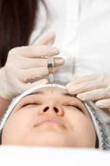Fototapeta premium The cosmetologist performs the injection