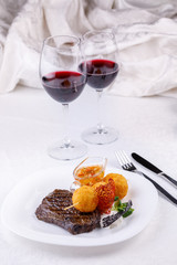 Beef steak with a garnish of potato balls.