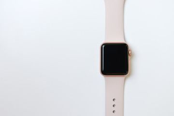 Closeup of Pink woman smart watch on the white background - flat lay