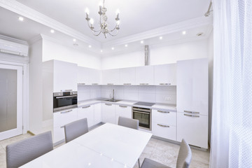 Modern design white kitchen in a spacious apartment.