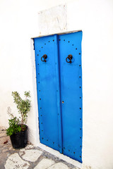 Old national Tunisian painted blue door in Medina of Tunisia on Mediterranean coast north africa / Architecture Arabic style, travel and holiday. Tourist season / Oriental and traditional.