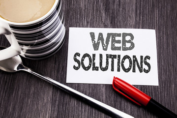 Conceptual hand writing text caption showing Web Solutions. Business concept for Internet Design Plan written on sticky note paper on the wooden wood background. With coffee and marker