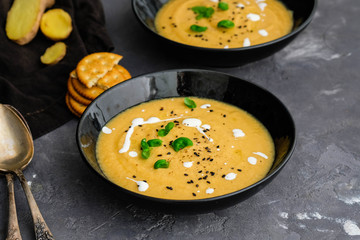 Vegetable cream soup with basil, black sesame and cheese biscuits.