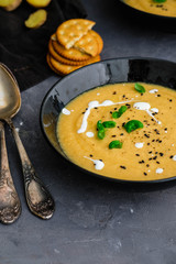 Vegetable cream soup with basil, black sesame and cheese biscuits.