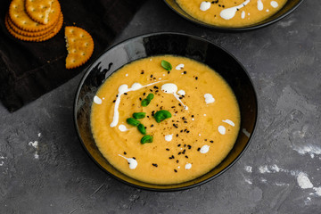 Vegetable cream soup with basil, black sesame and cheese biscuits.