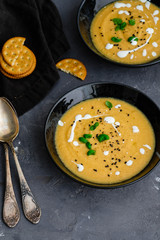 Vegetable cream soup with basil, black sesame and cheese biscuits.