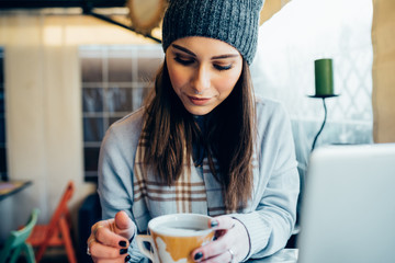 young woman outdoor sitting bat holding teacup looking away pensive - simplicity, thinking future,...