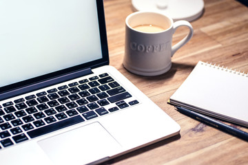 Laptop ,notebook ,pen and coffee on wood table