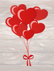 Balloons in the shape of heart bandaged with ribbon and bow