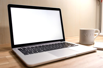 Laptop ,notebook ,pen and coffee on wood table