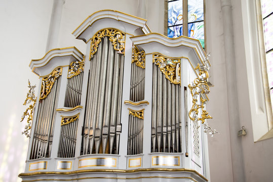 The pipe organ is a musical instrument that produces sound by driving pressurized air (called wind) through organ pipes selected via a keyboard.