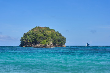 Beautiful small island and sailing ship view in the ocean