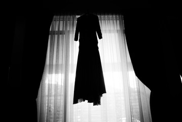 silhouette wedding dress in the window of the hotel