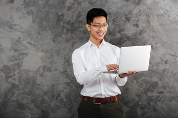 Portrait of a smiling young asian man dressed in shirt