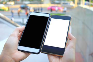 woman hand holding two smartphone with blank screen