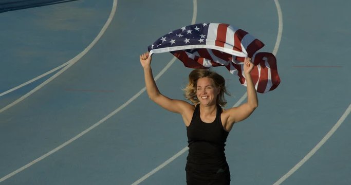 An American Athlete celebrates with the National Flag of the United States of America.