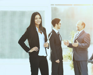 the Secretary in the office on the background of business team