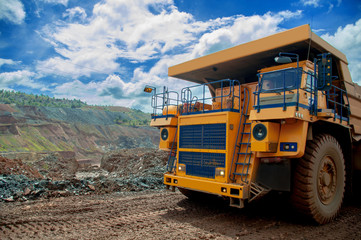 the dump truck transports iron ore. Colorful quarry.