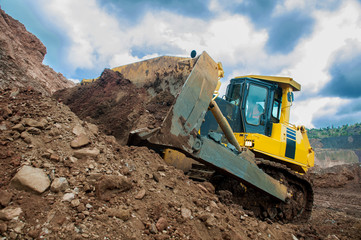 Bulldozer operation in the ore quarry. Daylighting
