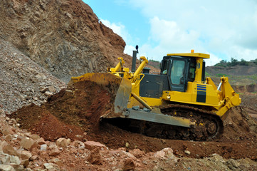Bulldozer operation in the ore quarry. Daylighting