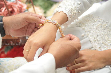 the bridegroom put on a bracelet on the bride