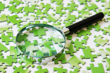 magnifying glass on the green puzzle