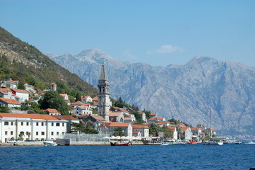 Fototapeta na wymiar City Perast on a mountainside in the Bay of Kotor on the background of Kotor.
