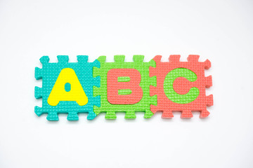 Foam puzzle with word on a white background.