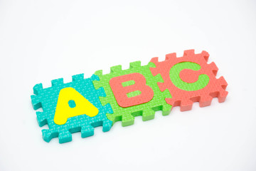 Foam puzzle with word on a white background.