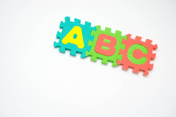 Foam puzzle with word on a white background.