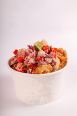 pieces of fried chicken with spicy seasoning, in a white plastic bowl