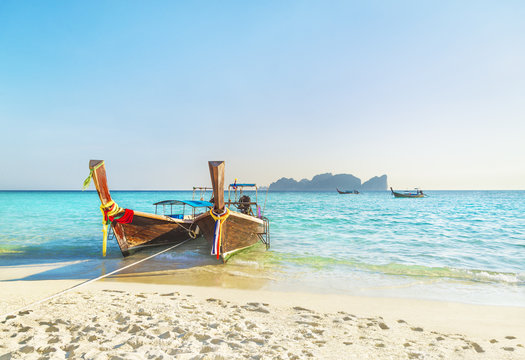 Two traditional thai longtail boats at famous sunset Long Beach, Thailand, Koh Phi Phi Don island, Krabi province, Andaman sea