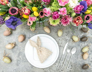 Fototapeta na wymiar Table decoration colorful spring flowers Easter eggs