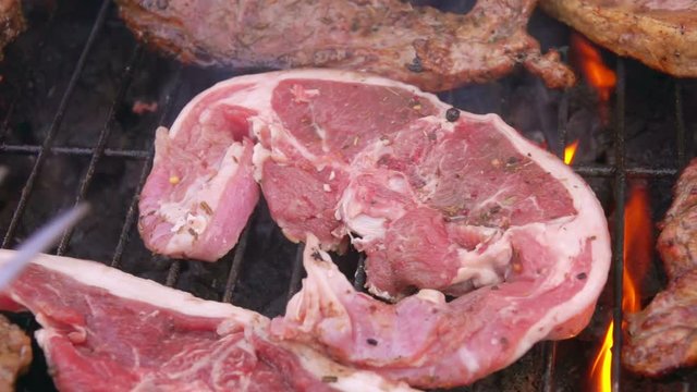 Pieces of mouth-watering lamb steak are laid on the grill