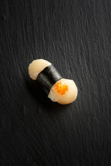 Japanese sushi with scallop on a black background side view from above.