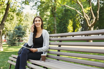 Smiling woman talking on mobile phone outdoors