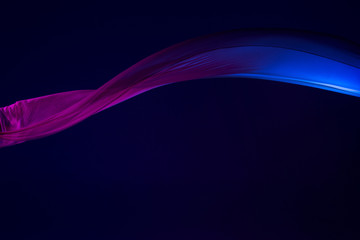 Smooth elegant transparent blue cloth separated on blue background.