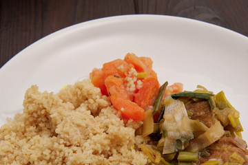 Wheat gluten on leek with couscous on a table