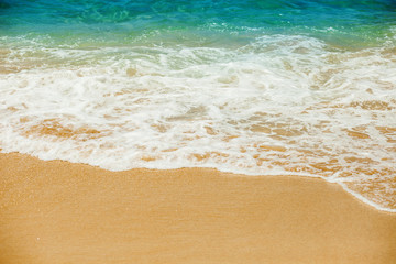 Fototapeta na wymiar Sea wave to the sandy beach