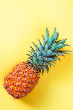 Pineapple on yellow background vertically
