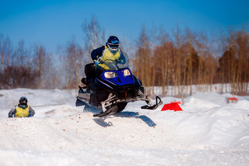 Snowmobile. Snowmobile races in snow. Concept team of friends chasing mountains.